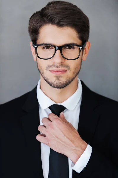 Businessman adjusting his necktie — Stock Photo, Image