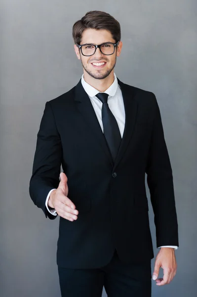 businessman stretching out hand for shaking