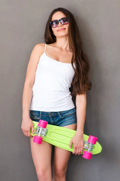 Woman holding colorful skateboard — Stock Photo, Image