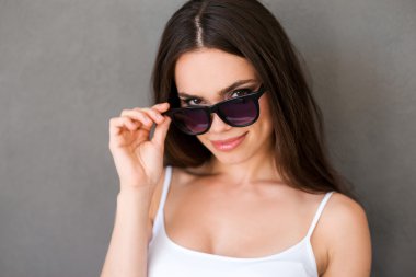 Smiling young woman adjusting eyewear