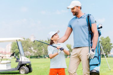 man and his son on golf course