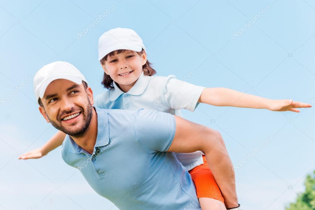 man carrying his son on shoulders