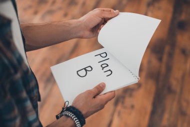 man turning page of his note pad