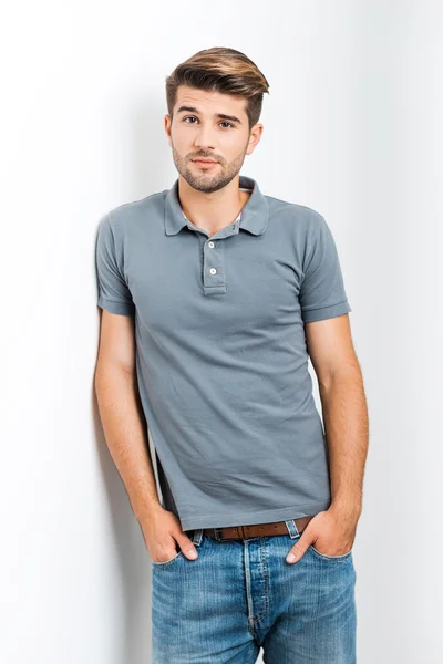 Handsome man holding hands in pockets — Stock Photo, Image