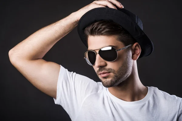 Young man adjusting his hat — Stock Photo, Image