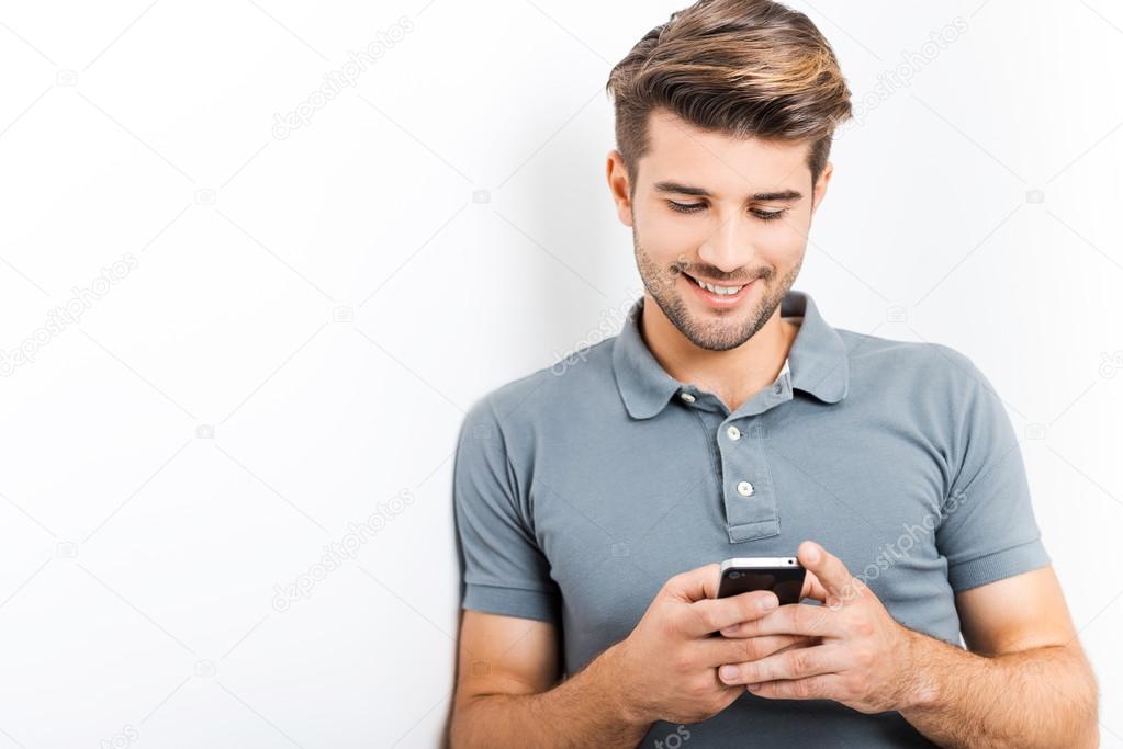Handsome man holding mobile phone