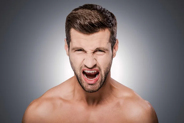 Furious young shirtless man — Stock Photo, Image