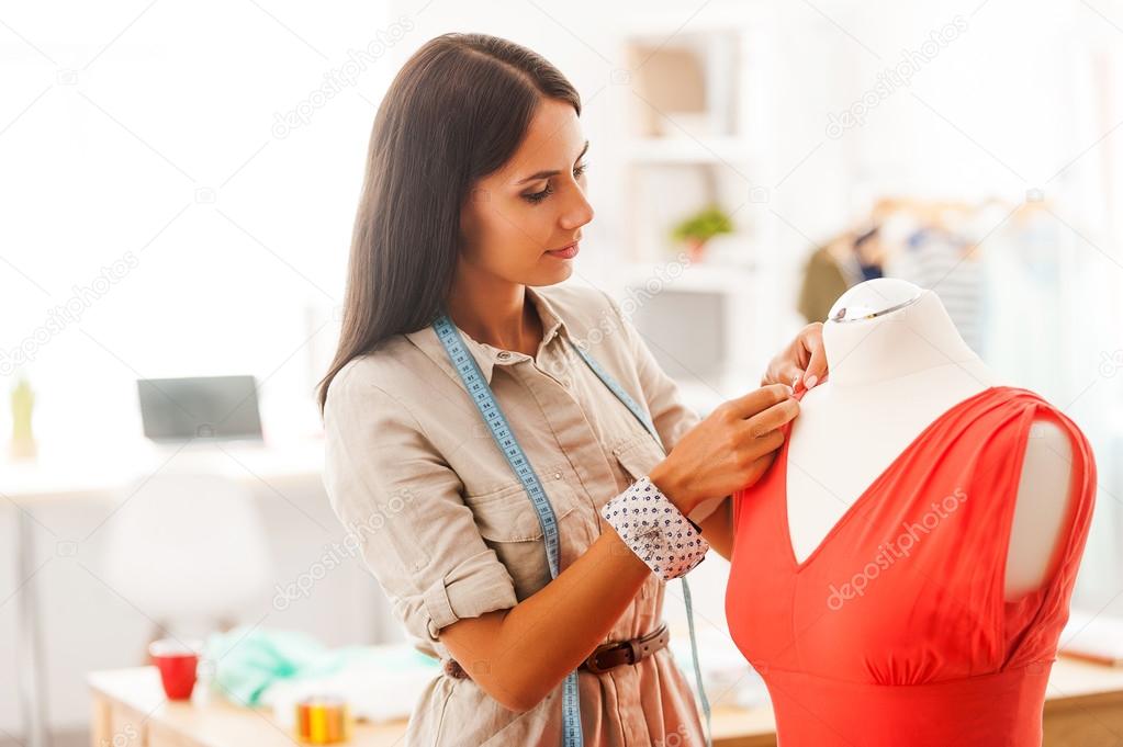 woman pinning textile on dress
