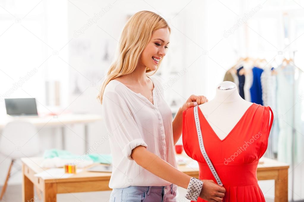 woman taking measurements from dress