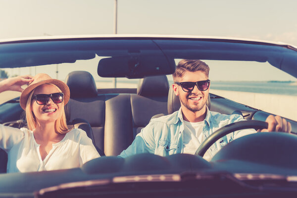 couple riding in their convertible