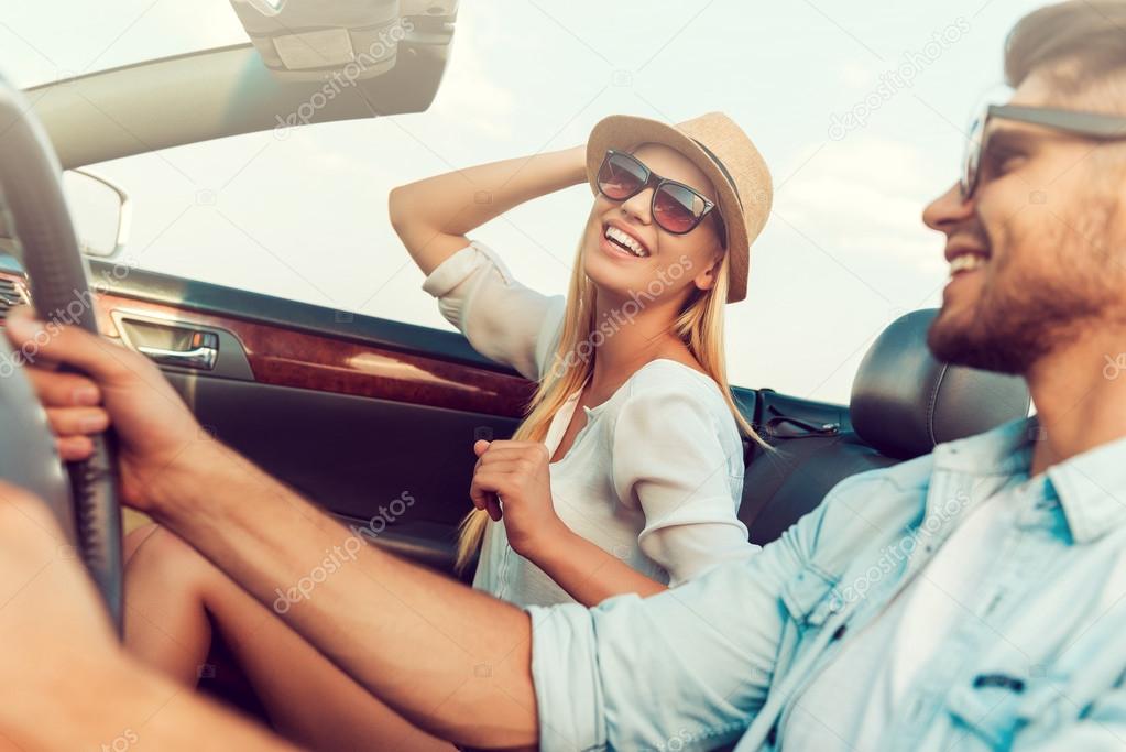 woman with her boyfriend driving convertible