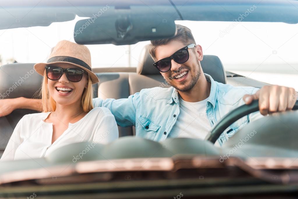 couple riding in their convertible