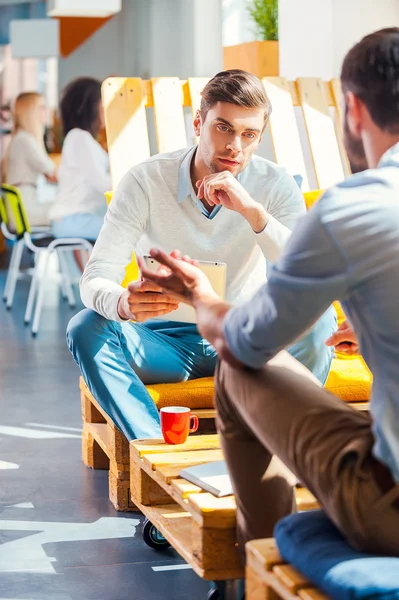 Young men discussing something in office — Stock Photo, Image