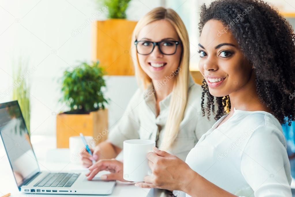 young women sitting at working place