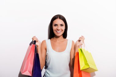 woman in dress carrying shopping bags