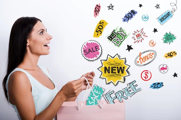 Woman in dress carrying shopping bag — Stock Photo, Image