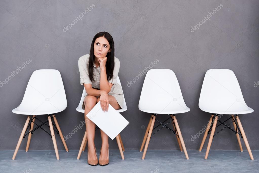 Bored young businesswoman holding paper