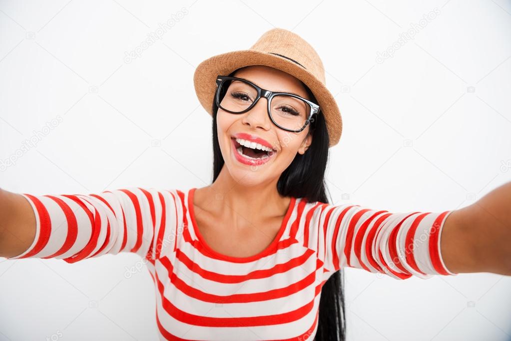 Happy young woman making selfie