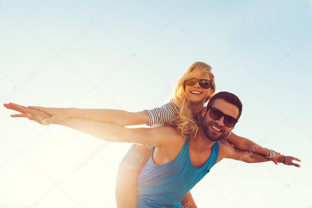 young man piggybacking his girlfriend