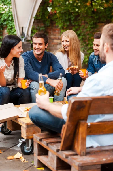 People talking and eating pizza — Stock Photo, Image