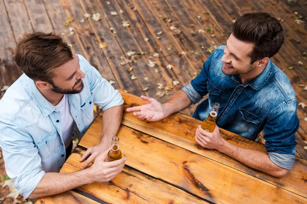 Homens bebendo cerveja e conversando uns com os outros — Fotografia de Stock