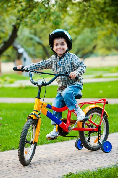 Cheerful little boy riding on bicycle — Stock Photo, Image