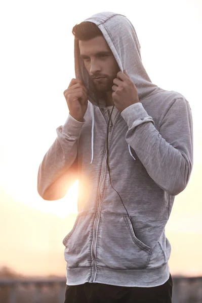 Thoughtful  man adjusting his hood — Stock Photo, Image