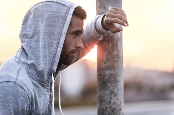 Thoughtful young man wearing hood — Stock Photo, Image