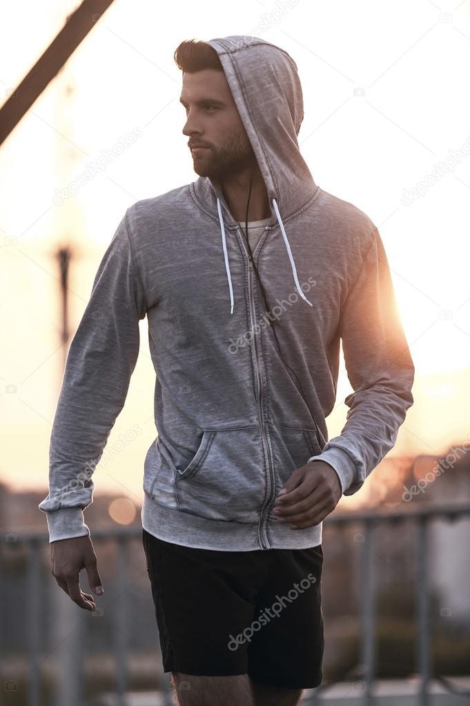man in sports clothing walking outdoors