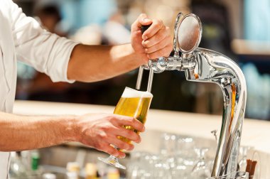 bartender pouring beer at the bar counter