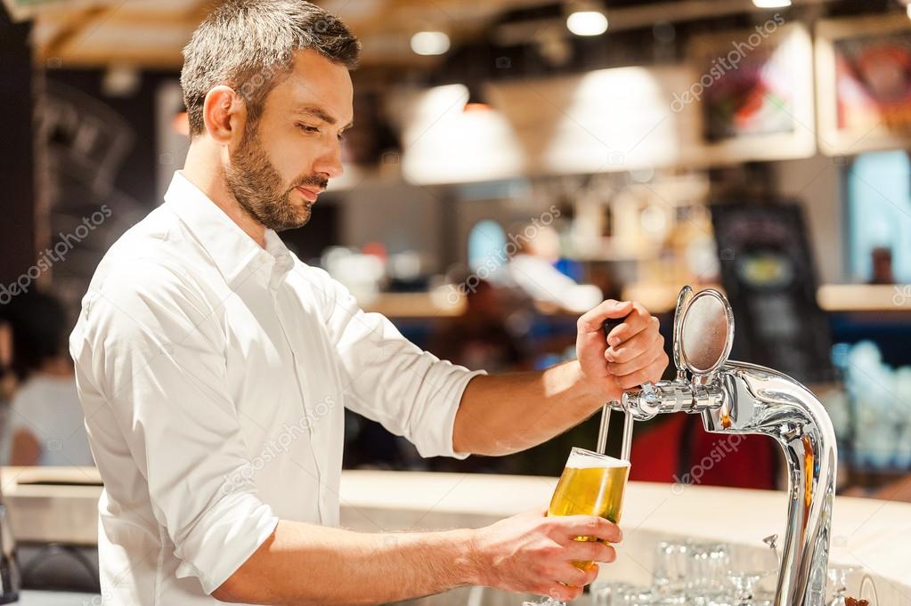 bartender pouring beer at the bar counter
