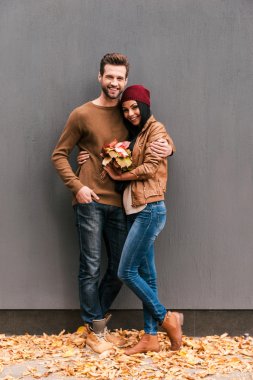 Sonbahar yaprakları ile güzel genç Çift