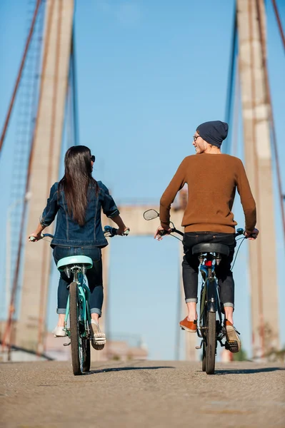 Casal andar de bicicleta ao longo da ponte — Fotografia de Stock