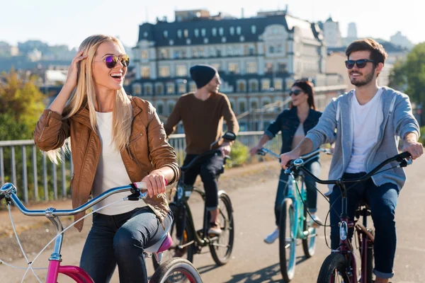 Woman riding bicycle with — Stockfoto