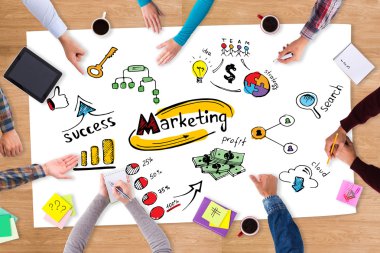 paper with marketing sketch and people around