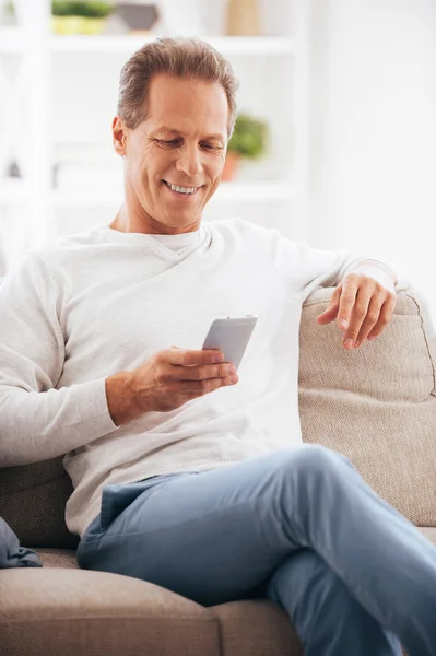 Zralý muž drží mobilní telefon — Stock fotografie