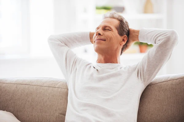 Mature man holding hands behind head — Stock Photo, Image