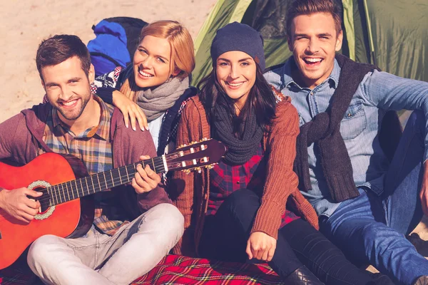 Leute, die mit Gitarre neben dem Zelt sitzen — Stockfoto