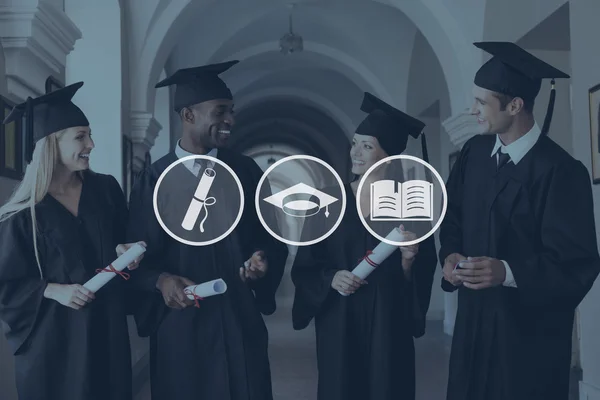 Graduados universitarios en vestidos de graduación — Foto de Stock