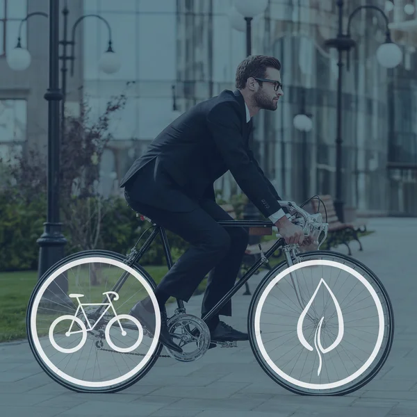 Businessman riding on his bicycle — Stock Photo, Image