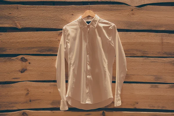 White shirt hanging on wall — Stock Photo, Image