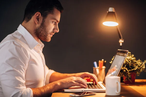 Young man working on his laptop — Stock Photo, Image