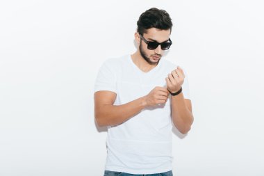 Indian man adjusting his bracelet