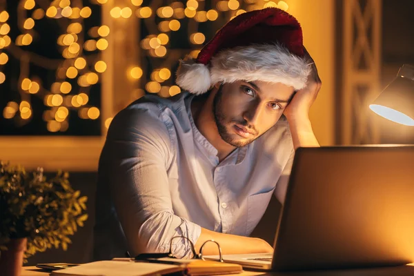 Frustrated young man in Santa hat — Stock Photo, Image