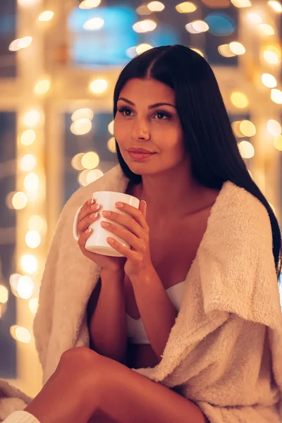 Woman in underwear   holding coffee cup — Stockfoto