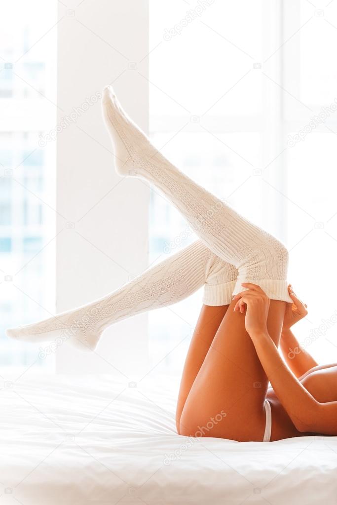 woman in lingerie taking of her white socks