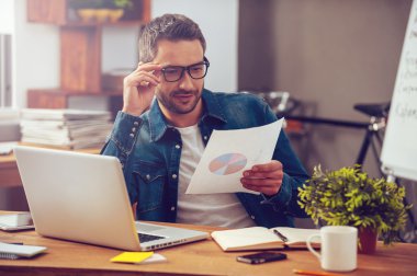 man holding paper with colorful diagram