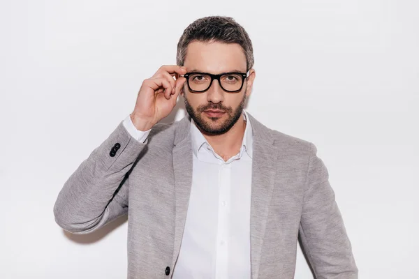 Confident mature man adjusting his eyeglasses — Stock Photo, Image