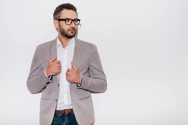 Confident mature man adjusting his jacket — Stock Photo, Image