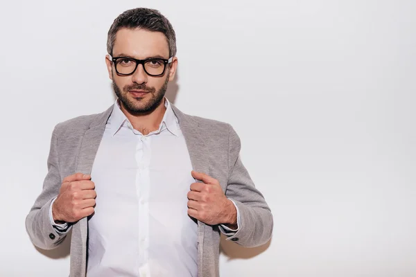 Mature man adjusting his jacket — Stock Photo, Image